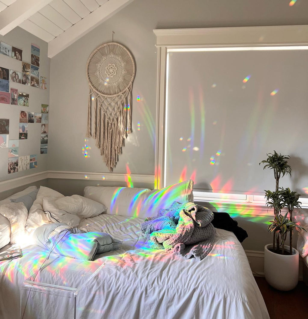 Rainbows thrown across a real room by a Glimmerprism suncatcher in direct sun
