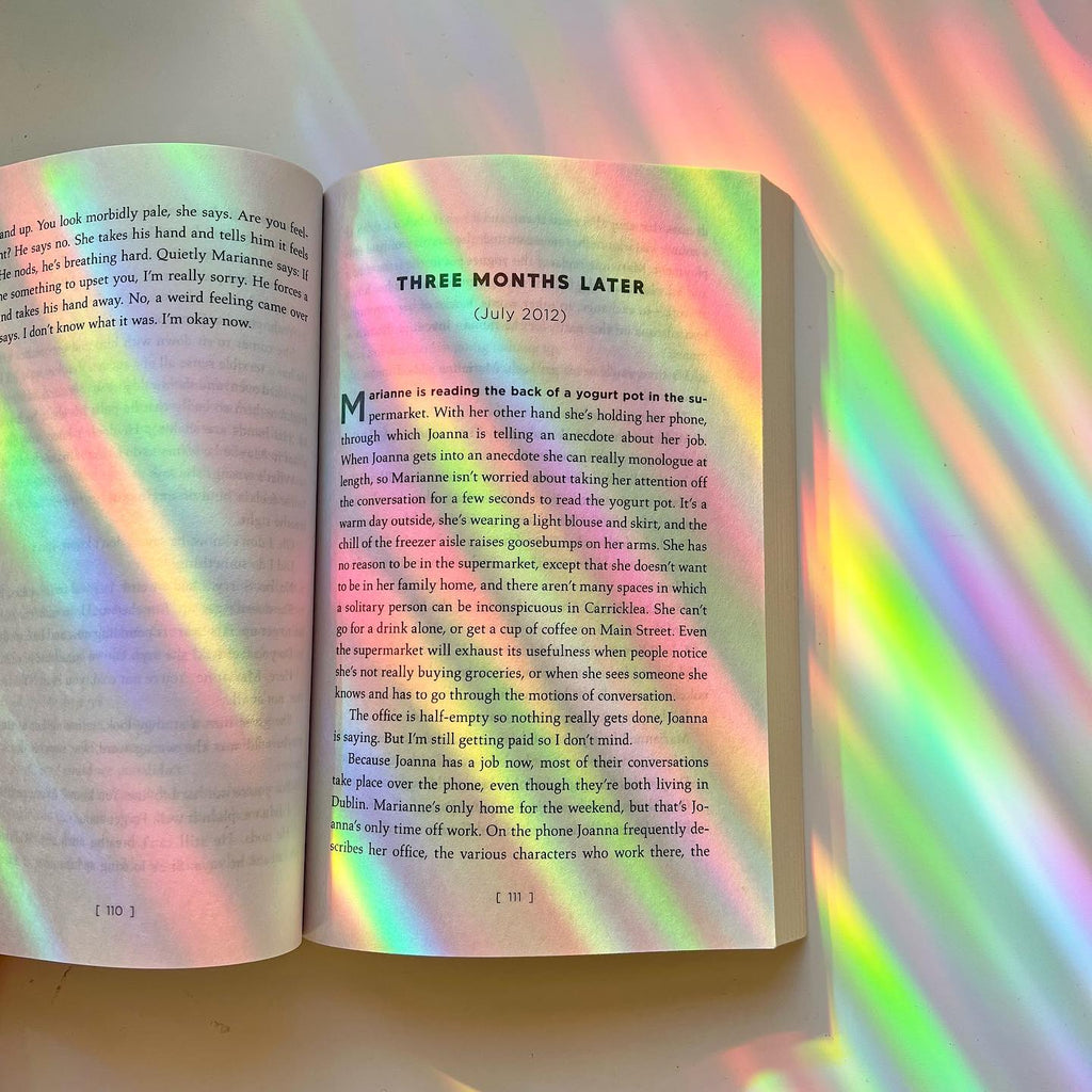 Rainbows thrown across a real room by a Glimmerprism suncatcher in direct sun
