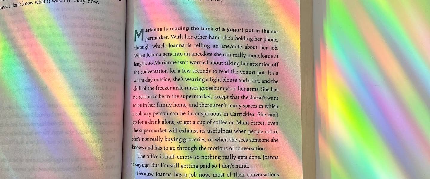 Rainbows thrown across a real room by a Glimmerprism suncatcher in direct sun