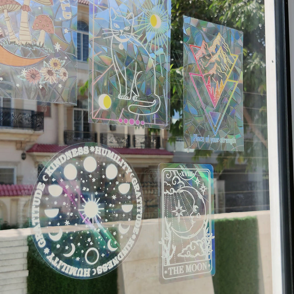 Several suncatcher designs on one sunlit window
