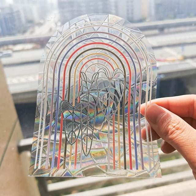 Boho Rainbow Arch suncatcher sticker held to the light