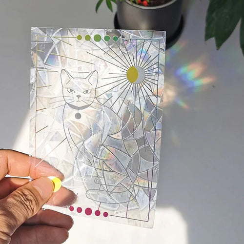 Celestial Cat suncatcher sticker held to the light