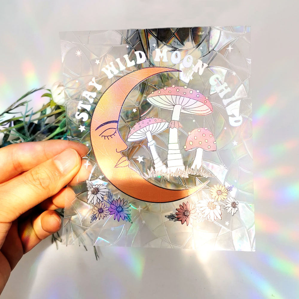 Stay Wild Moon Child suncatcher sticker held to the light