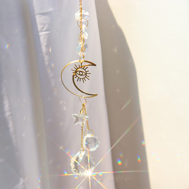 Sun and Moon crystal prism hanging against a curtain