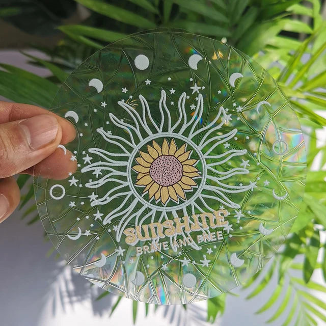 Sunshine Mandala suncatcher sticker held to the light