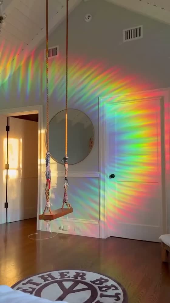 A bedroom wall with a huge rainbow arch