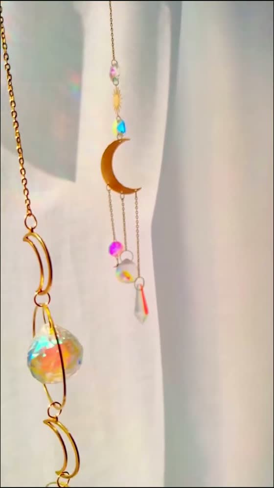 A gold crystal hanging by a curtain